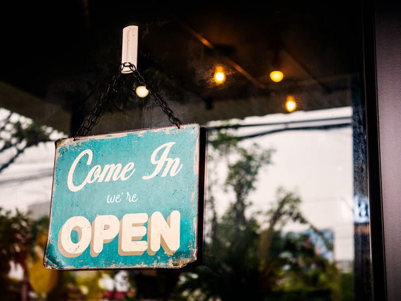 An "open" sign on the front of a small business