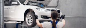 Woman observing a car that is in suspension